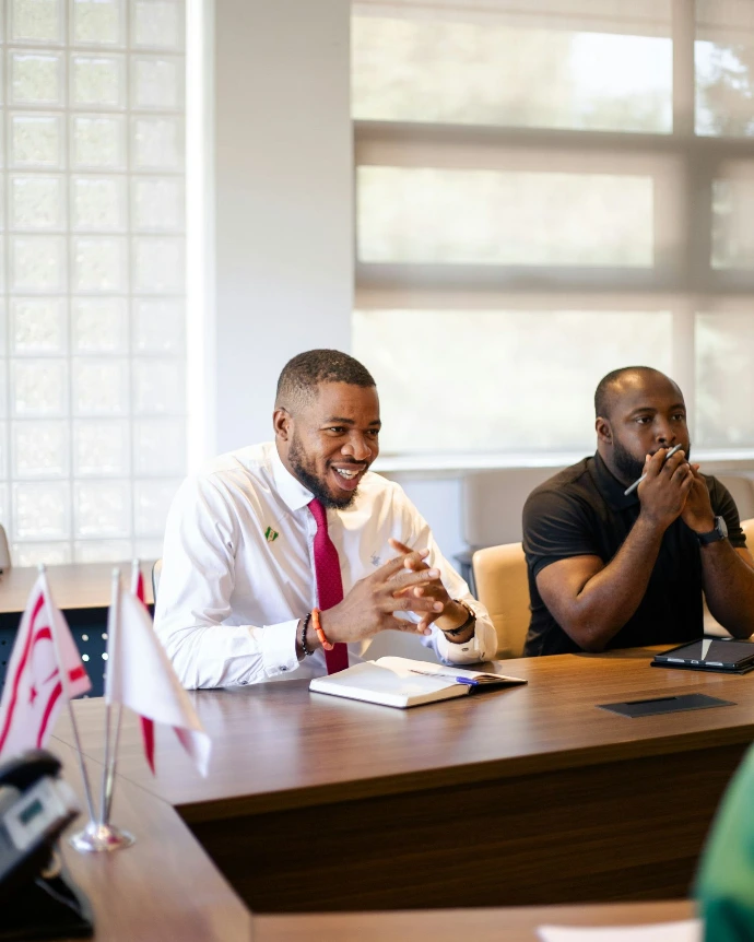 Two men in a meeting at a conference table.